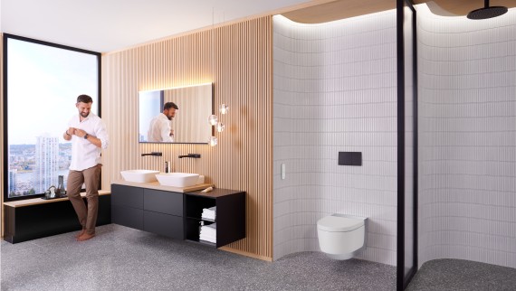 Man in Geberit ONE badkamer met Geberit AquaClean Mera en Geberit Option Plus Spiegel