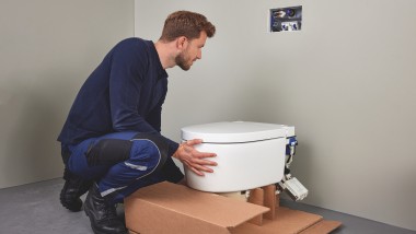 Sanitair installateur die een douche-wc installeert