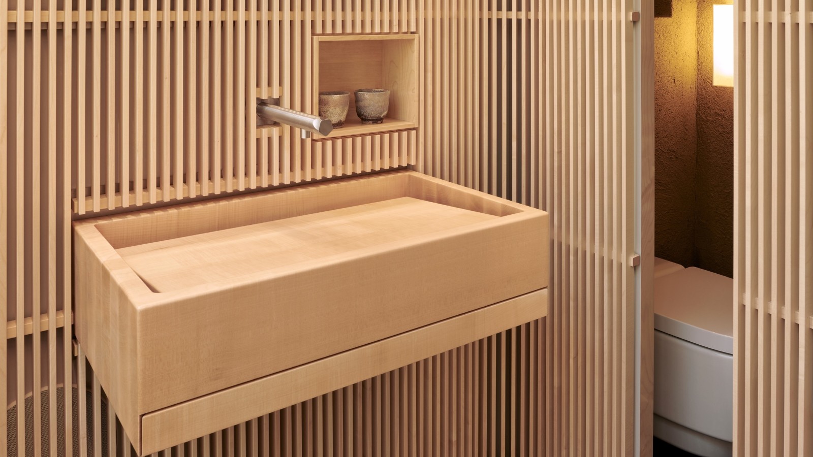 Equipées d’un WC-douche Geberit, les toilettes sont pensées comme un refuge, sans aucun stimulus visuel superflu. (© David Willen Studio)